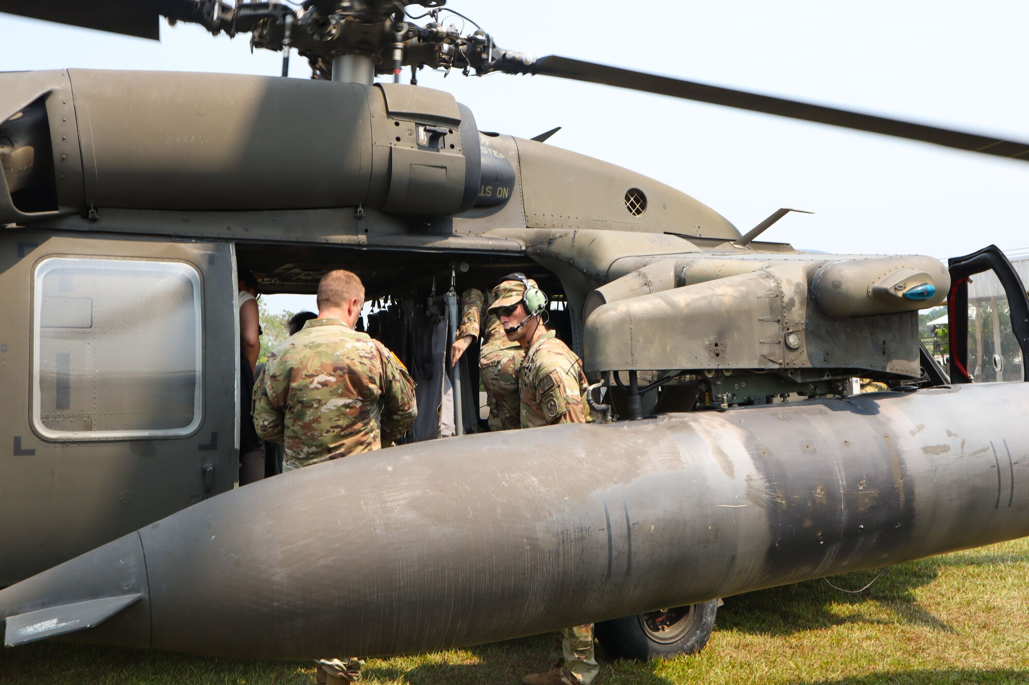 A soldier loading a helicopter.