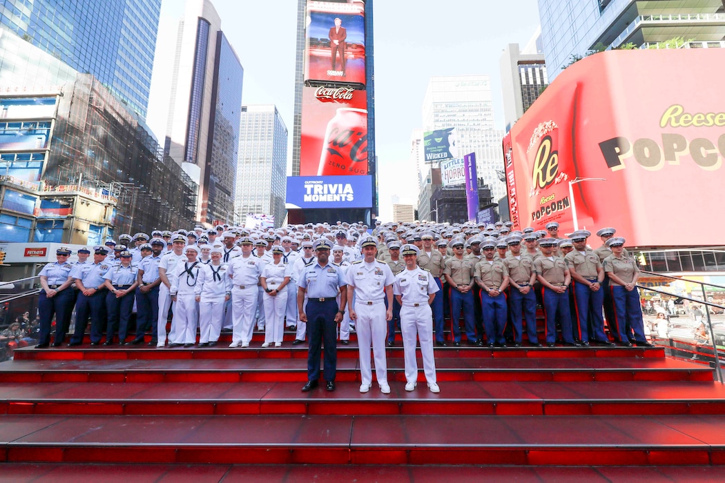 U.S. Navy Sailors and Marines pose in Times Square