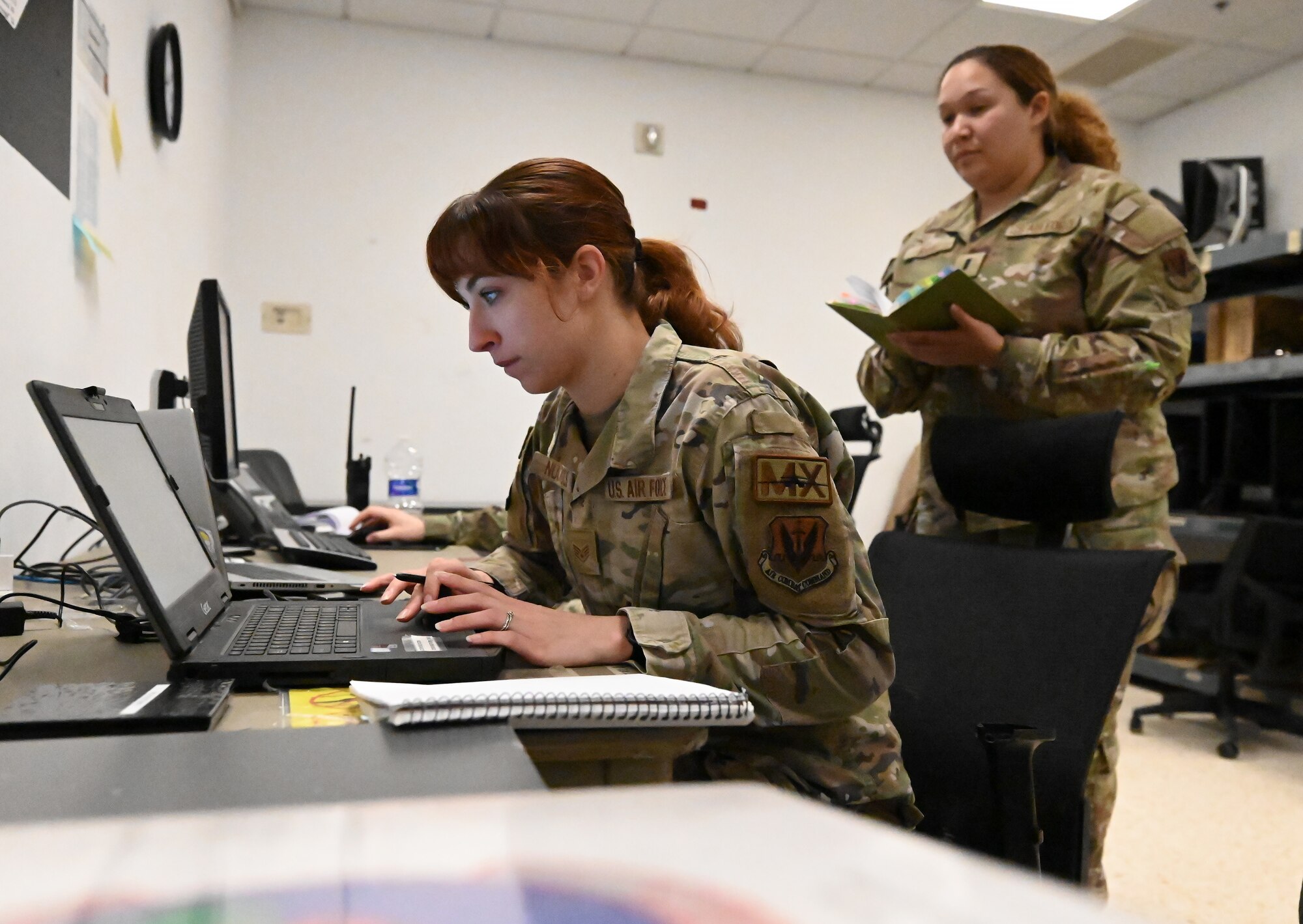 Staff Sgt. Chloe Nuckols, 16th Electronic Warfare Squadron mission data specialist, shows the deployable diagnostic system to 1st Lt. Miriansky Rivas, 16th EWS B-1 mission data engineer, at Morón Air Base, Spain, April 8, 2024. This is the first time the 16th EWS has supported a B-1B Lancer Bomber Task Force. The new partnership bridges the gap between B-1 engineers and aircrew by obtaining new data and mission flight information to supplement intelligence sources and complete rapid reprogramming for the electronic warfare system. (U.S. Air Force photo by Staff Sgt. Holly Cook)