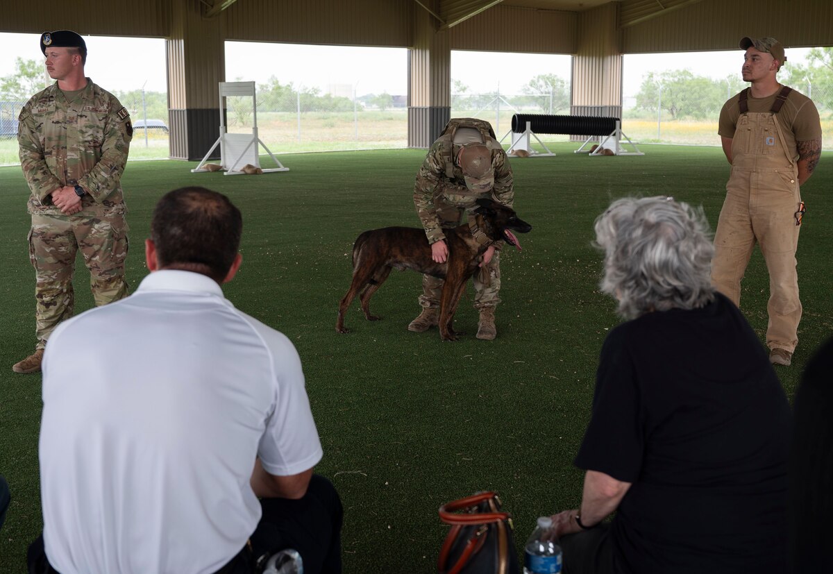 U.S. Air Force Senior Airman Joshua Korman, 17th Security Forces Military Working Dog handler, and MWD Borys present a K-9 demonstration to the 17th Training Wing honorary commanders during the 17th Mission Support Group immersion at Goodfellow Air Force Base, Texas, May 23, 2024. The immersion concluded with a visit to the 17th SFS, where the honorary commanders learned about the squadron's efforts to keep Goodfellow secure, including base safety, weapons training, and agile operations worldwide. (U.S. Air Force photo by Senior Airman Sarah Williams)