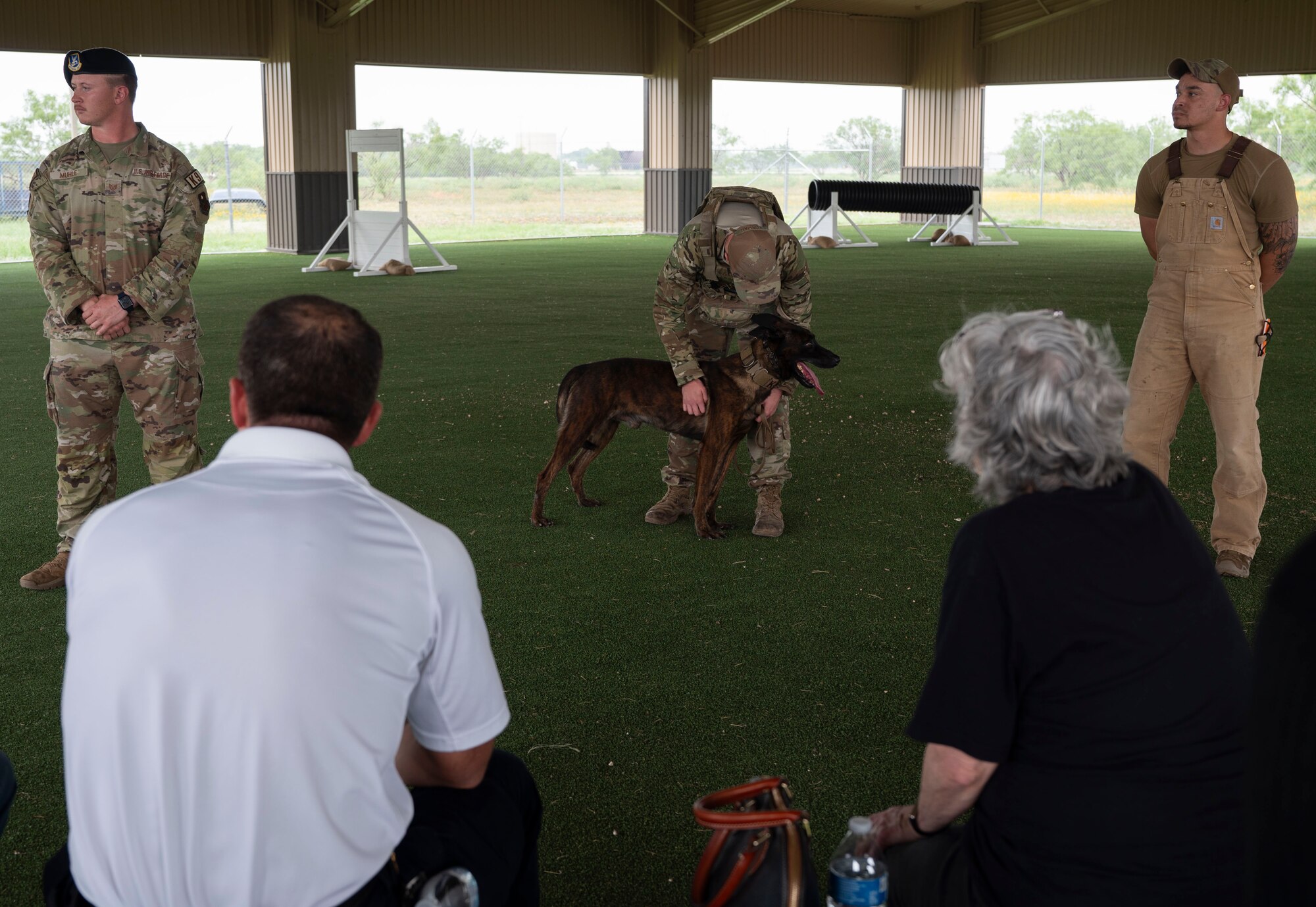 U.S. Air Force Senior Airman Joshua Korman, 17th Security Forces Military Working Dog handler, and MWD Borys present a K-9 demonstration to the 17th Training Wing honorary commanders during the 17th Mission Support Group immersion at Goodfellow Air Force Base, Texas, May 23, 2024. The immersion concluded with a visit to the 17th SFS, where the honorary commanders learned about the squadron's efforts to keep Goodfellow secure, including base safety, weapons training, and agile operations worldwide. (U.S. Air Force photo by Senior Airman Sarah Williams)