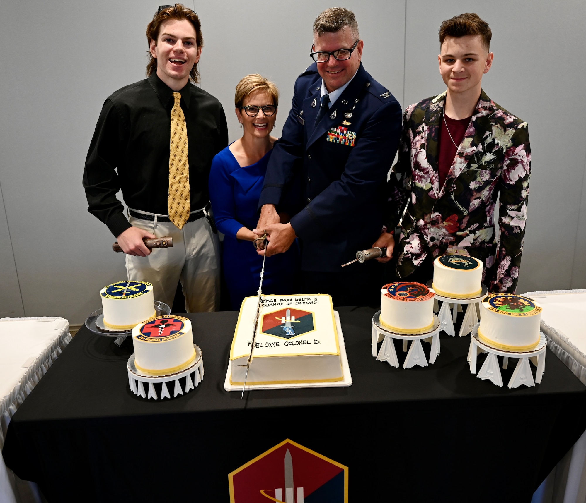 Col Dermanoski and his family ceremoniously cut the cake after the change of command ceremony.