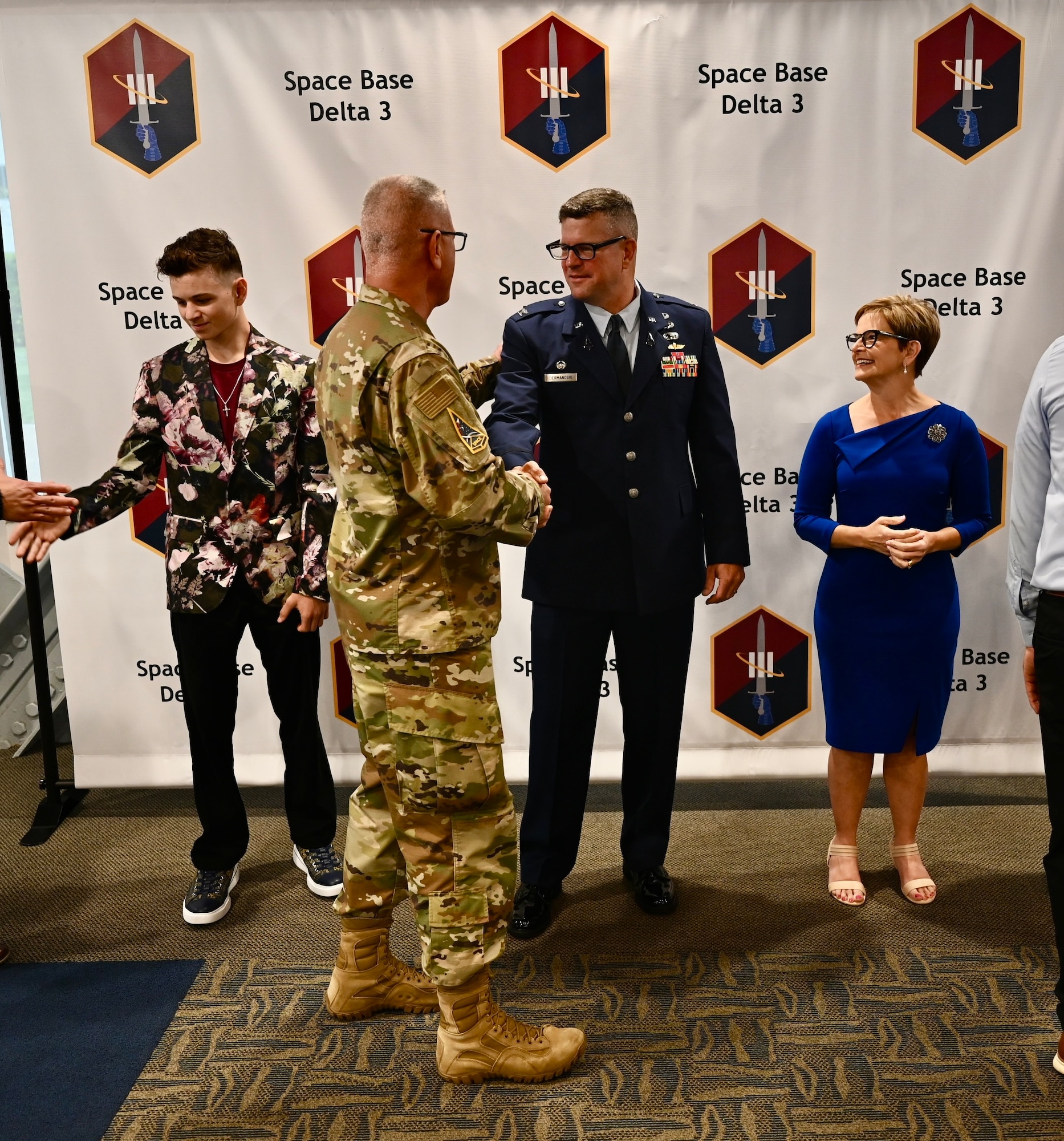 Patrons from the change of command ceremony join a receiving line to meet Col Dermanoski and his family.