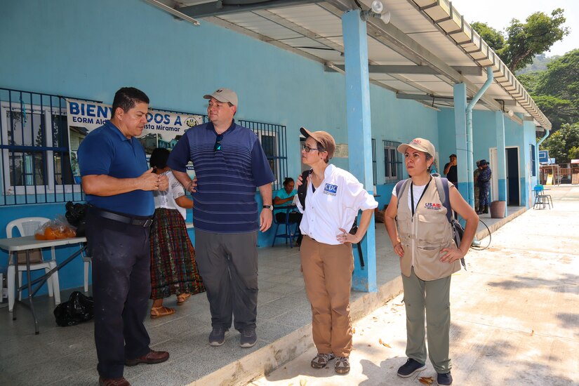 A photo of a group of people talking.