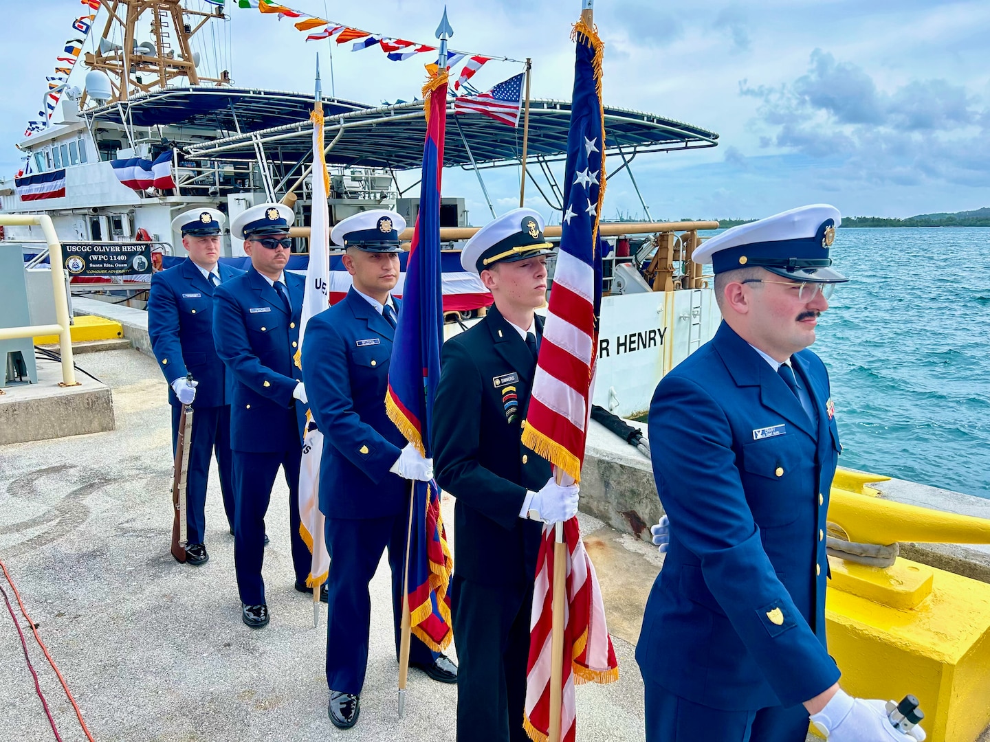 The colorguard stands by ahead of a U.S. Coast Guard Forces Micronesia Sector Guam change of command ceremony at Victor Pier in Apra Harbor, Guam, on May 23, 2024. Capt. Rob Kistner, a native of Rochester, New York, joins the Forces Micronesia team after serving as the chief of Prevention for the U.S. Coast Guard 14th District. (U.S. Coast Guard photo by Lt. Whip Blacklaw)