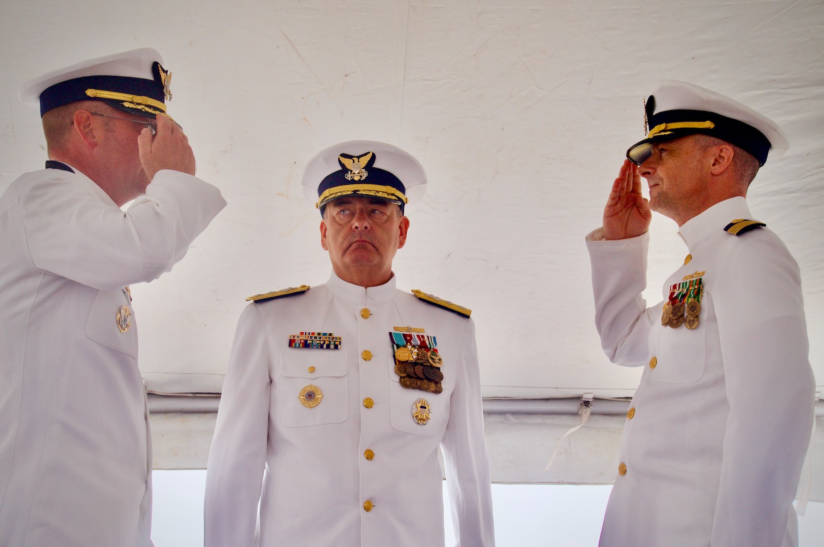 Capt. Rob Kistner takes command of U.S. Coast Guard Forces Micronesia Sector Guam from Capt. Nick Simmons in a change of command ceremony at Victor Pier in Apra Harbor, Guam, on May 23, 2024. Rear Adm. Michael Day, U.S. Coast Guard 14th District commander, presided over the ceremony. Hailing from Tallahassee, Florida, Capt. Simmons leaves Guam to rejoin the staff at U.S. Coast Guard Headquarters as the chief of the Office of Budget and Programs (CG-82). Capt. Rob Kistner, a native of Rochester, New York, joins the Forces Micronesia team after serving as the chief of Prevention for the U.S. Coast Guard 14th District. (U.S. Coast Guard photo by Josiah Moss)