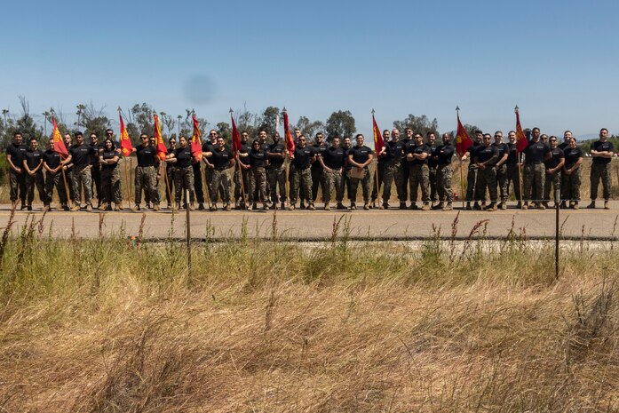 U.S. Marines with Recruiting Station San Diego pose for a photograph during the RS San Diego annual pool function on Marine Corps Air Station Miramar, Calif., May 18, 2024. The annual pool function is an opportunity for poolees to build camaraderie, strengthen their commitment to the Marine Corps, and prepare for recruit training by competing in athletic competitions and receiving military related periods of instruction. (U.S. Marine Corps photo by Sgt. Jesula Jeanlouis)
