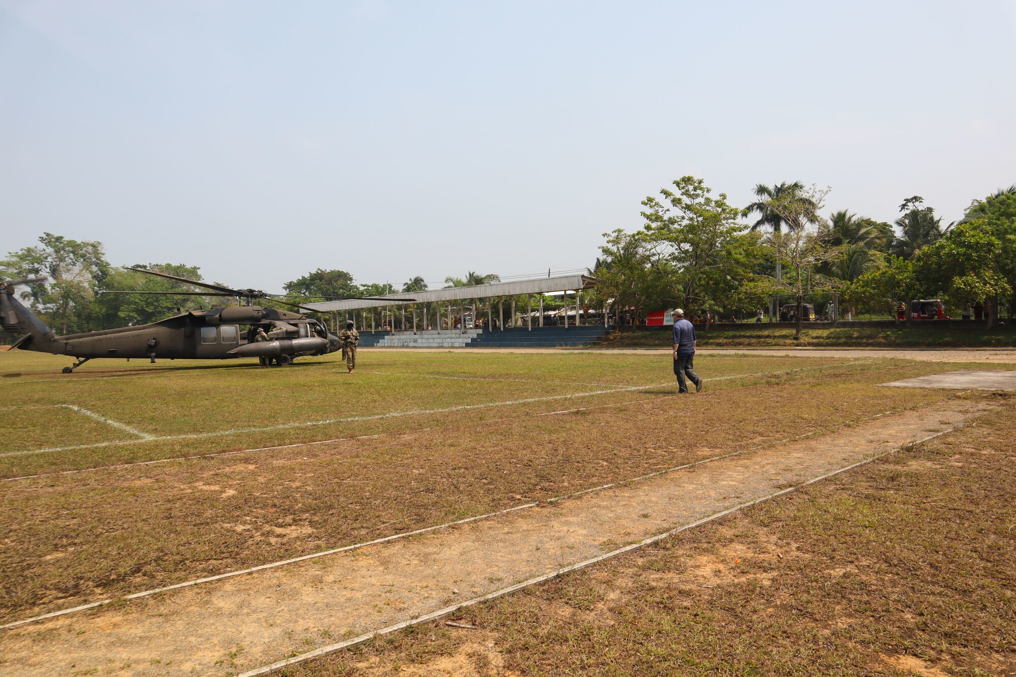A photo of people stepping to a helicopter.