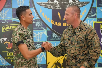 U.S. Marine Corps Col. Sean Dynan, right, commanding officer of the 15th Marine Expeditionary Unit gifts his command challenge coin to Malaysia Army Lt. Col. Mohd Zaki, commanding officer of 18th Battalion, Royal Malay Regiment, 10th Brigade (Para), during a key leader engagement at Sri Pantai Camp, Kuala Terengganu, Malaysia, May 28, 2024.