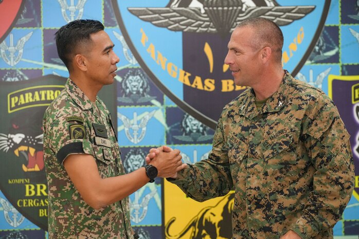 U.S. Marine Corps Col. Sean Dynan, right, commanding officer of the 15th Marine Expeditionary Unit gifts his command challenge coin to Malaysia Army Lt. Col. Mohd Zaki, commanding officer of 18th Battalion, Royal Malay Regiment, 10th Brigade (Para), during a key leader engagement at Sri Pantai Camp, Kuala Terengganu, Malaysia, May 28, 2024.