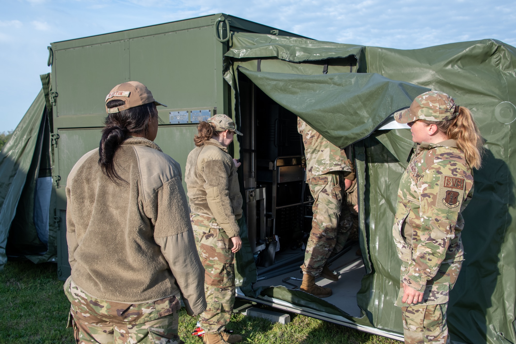 Air National Guard services Airman work outside of the ESPEK kitchen.