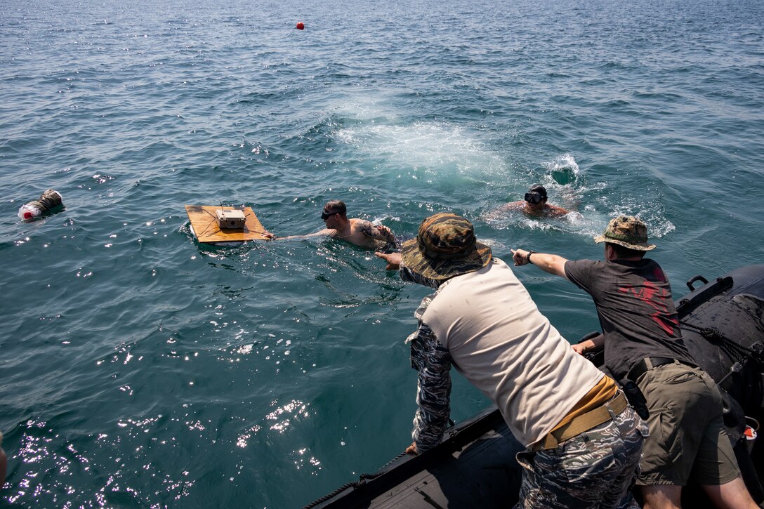 Explosive ordnance disposal technicians with the Philippine Marine Corps, Philippine Navy Special Operations Command, and U.S. Marine Corps transport a “Floating Freddy” towards a C-4 charge during underwater unexploded ordnance disposal demolitions off the coast of Caballo Island, Philippines, during Archipelagic Coastal Defense Continuum May 14, 2024. ACDC is a series of bilateral exchanges and training opportunities between U.S. Marines and Philippine Marines aimed at bolstering the Philippine Marine Corps’ Coastal Defense strategy while supporting the modernization efforts of the Armed Forces of the Philippines. This event marked the first time in U.S. Marine Corps EOD history that dive and demolition training on live underwater ordnance was conducted outside the continental United States. (U.S. Marine Corps photo by Staff Sgt. Dana Beesley)