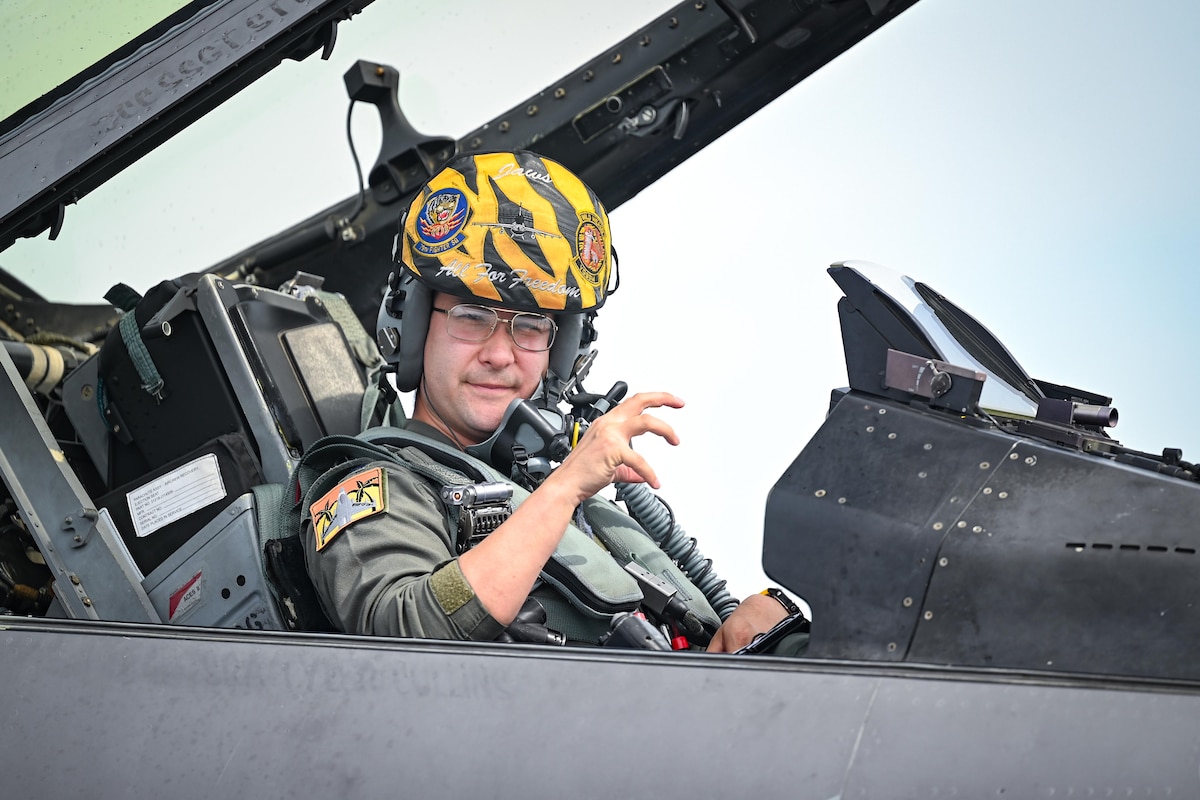A pilots displays squadron hand signals before takeoff
