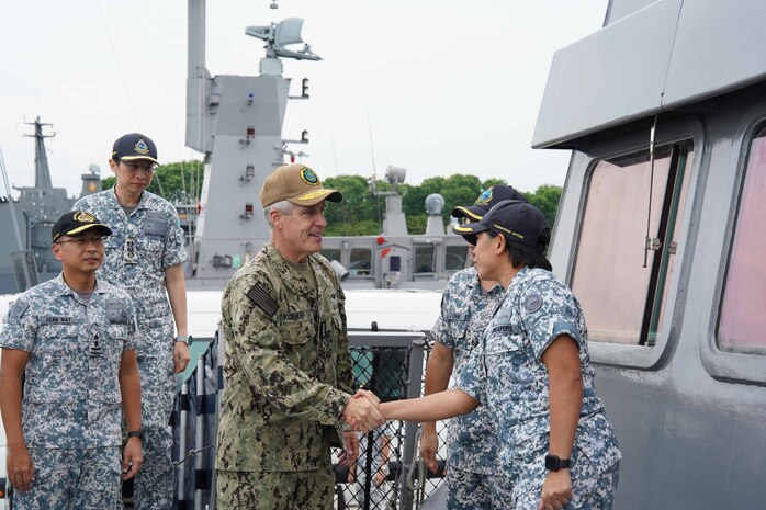 Adm. Stephen Koehler, commander, U.S. Pacific Fleet, center, greets Lt. Col. Sing Geok Wei, commanding officer of the Formidible-class stealth frigate RSS Supreme (FFG 73), right, prior to a ship tour on Changi Naval Base, Singapore, May 23, 2024. The visit to Singapore underscored the United States’ commitment to strengthening alliances and partnerships for an enduring resilient, free and open Indo-Pacific. (Photo courtesy of the Republic of Singapore Navy)