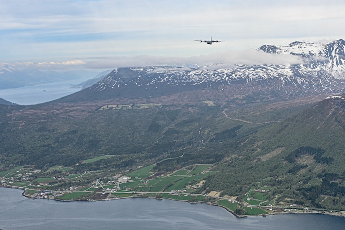 A C-130J Super Hercules assigned to Little Rock Air Force Base, Arkansas, flies over mountains in Norway, May 9, 2024. The C-130J Super Hercules serves as a cornerstone of strategic collaboration among Allied nations. Collaboration is at the core of the C-130J's mission. Designed with interoperability in mind, it seamlessly integrates with Allied forces, facilitating joint operations and enhancing military cooperation.
