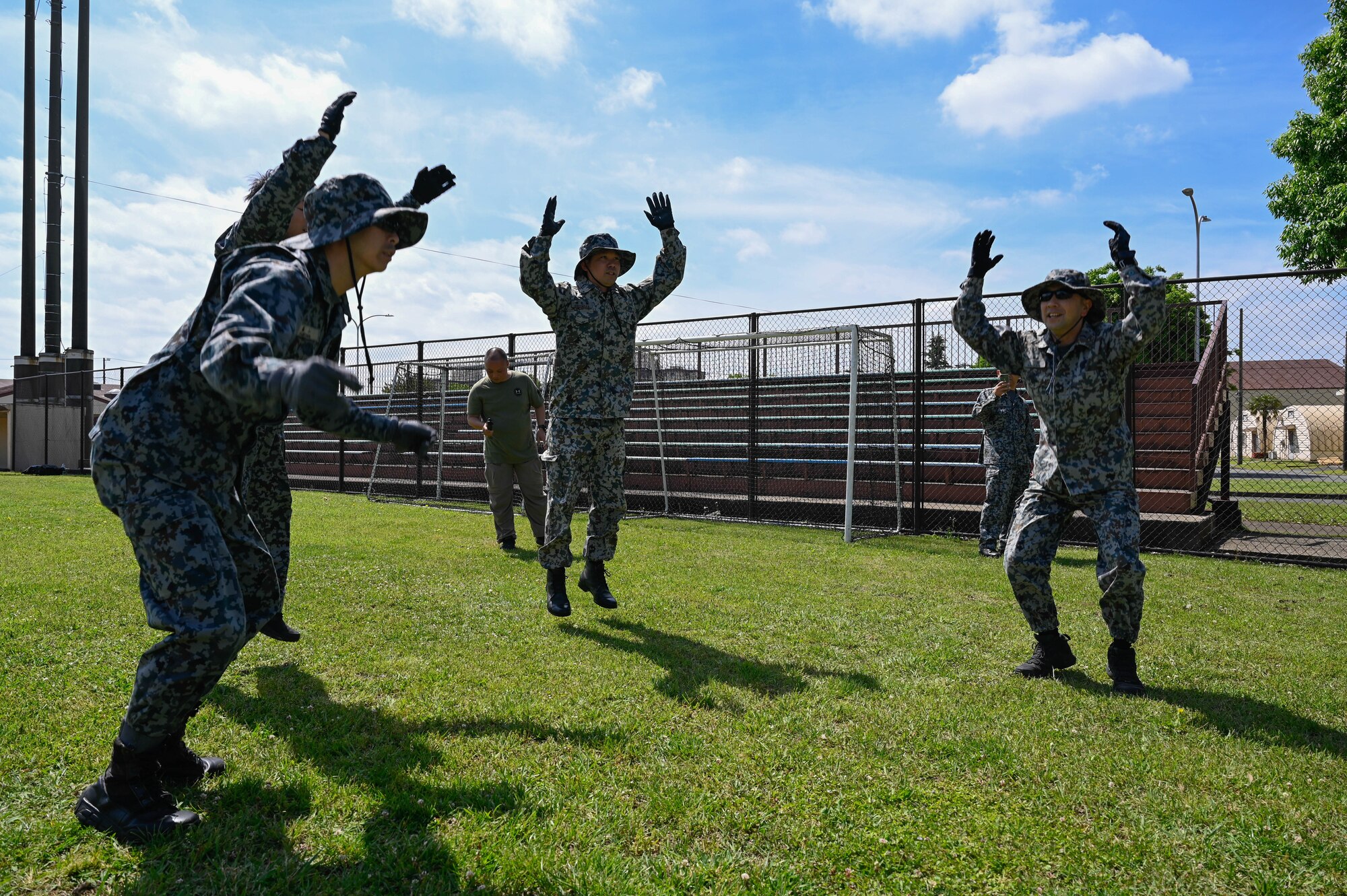 A team of people perform exercises.