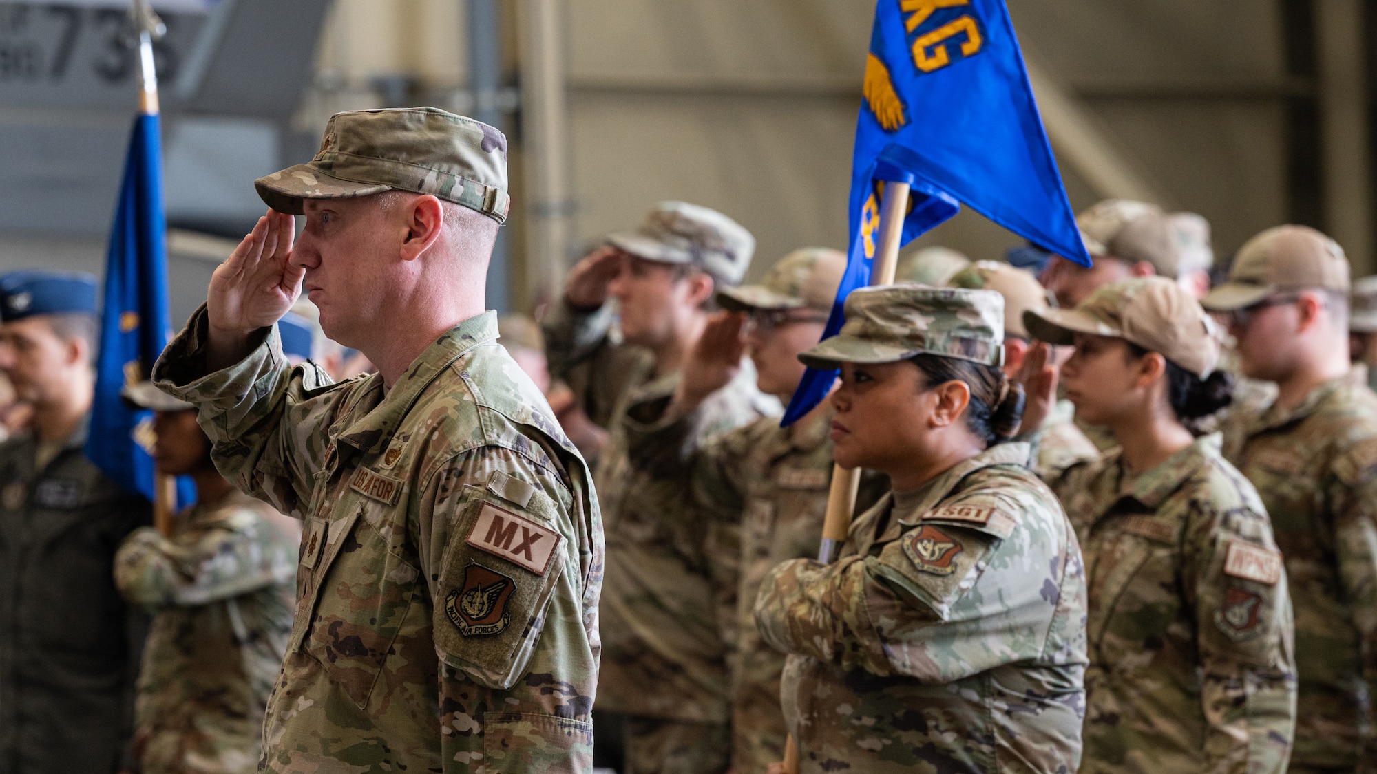 Members assigned to the 8th Maintenance Group render a salute during the 8th Maintenance Group change of command ceremony at Kunsan Air Base, Republic of Korea.
