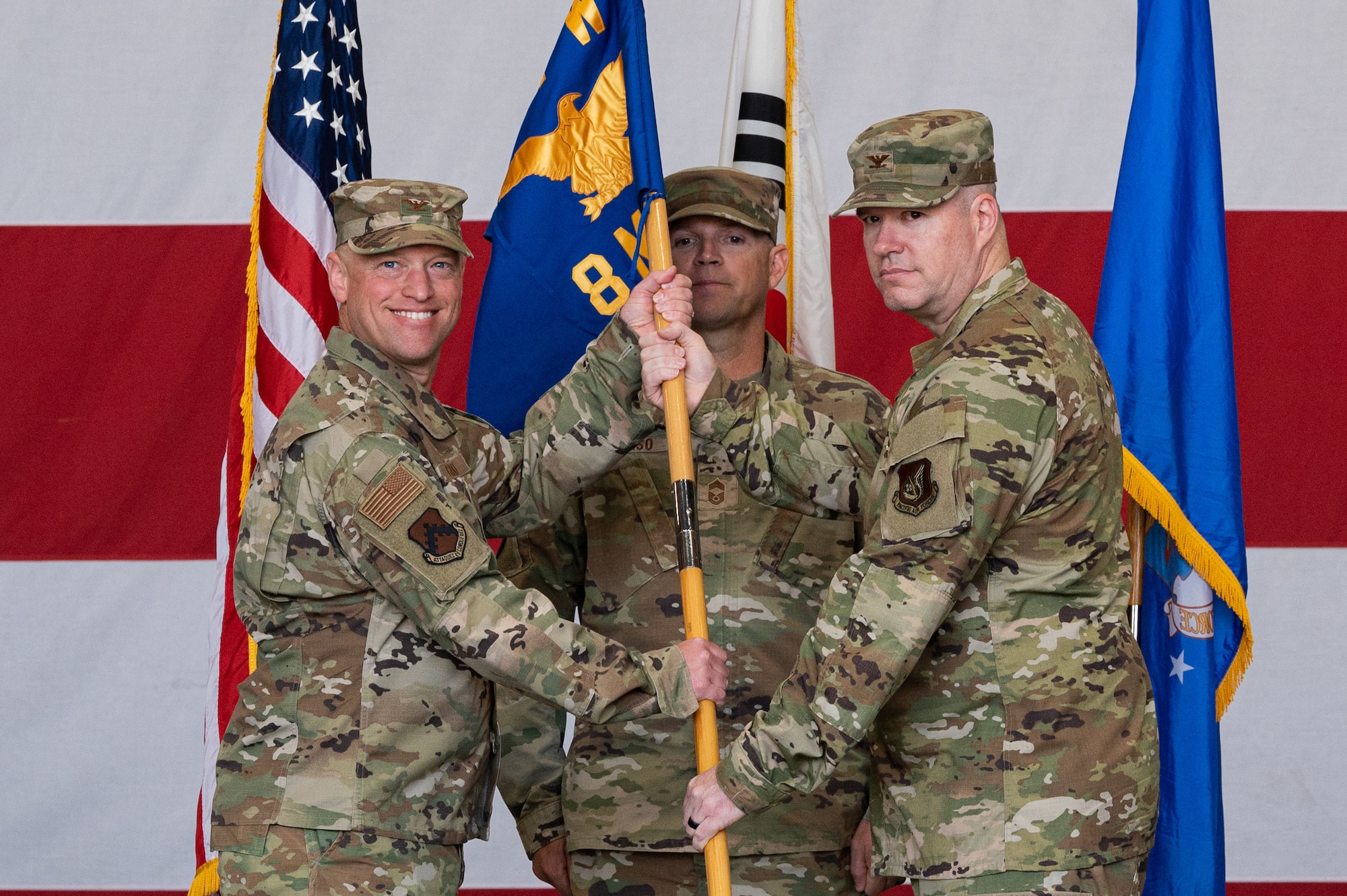 Col. Matthew Gaetke, left, 8th Fighter Wing commander, receives the 8th Maintenance Group guidon from Col. Bradley Altman, 8th MXG outgoing commander, during the 8th MXG change of command ceremony at Kunsan Air Base, Republic of Korea.