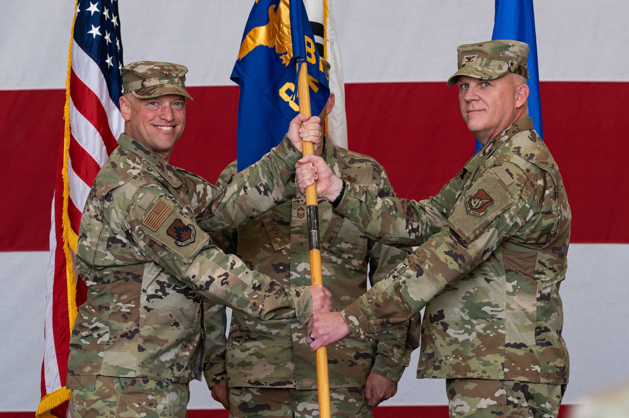 Col. Matthew Gaetke, left, 8th Fighter Wing commander, gives the guidon to Col. Casey Crabill, 8th Maintenance Group incoming commander, during the 8th MXG change of command ceremony at Kunsan Air Base, Republic of Korea.