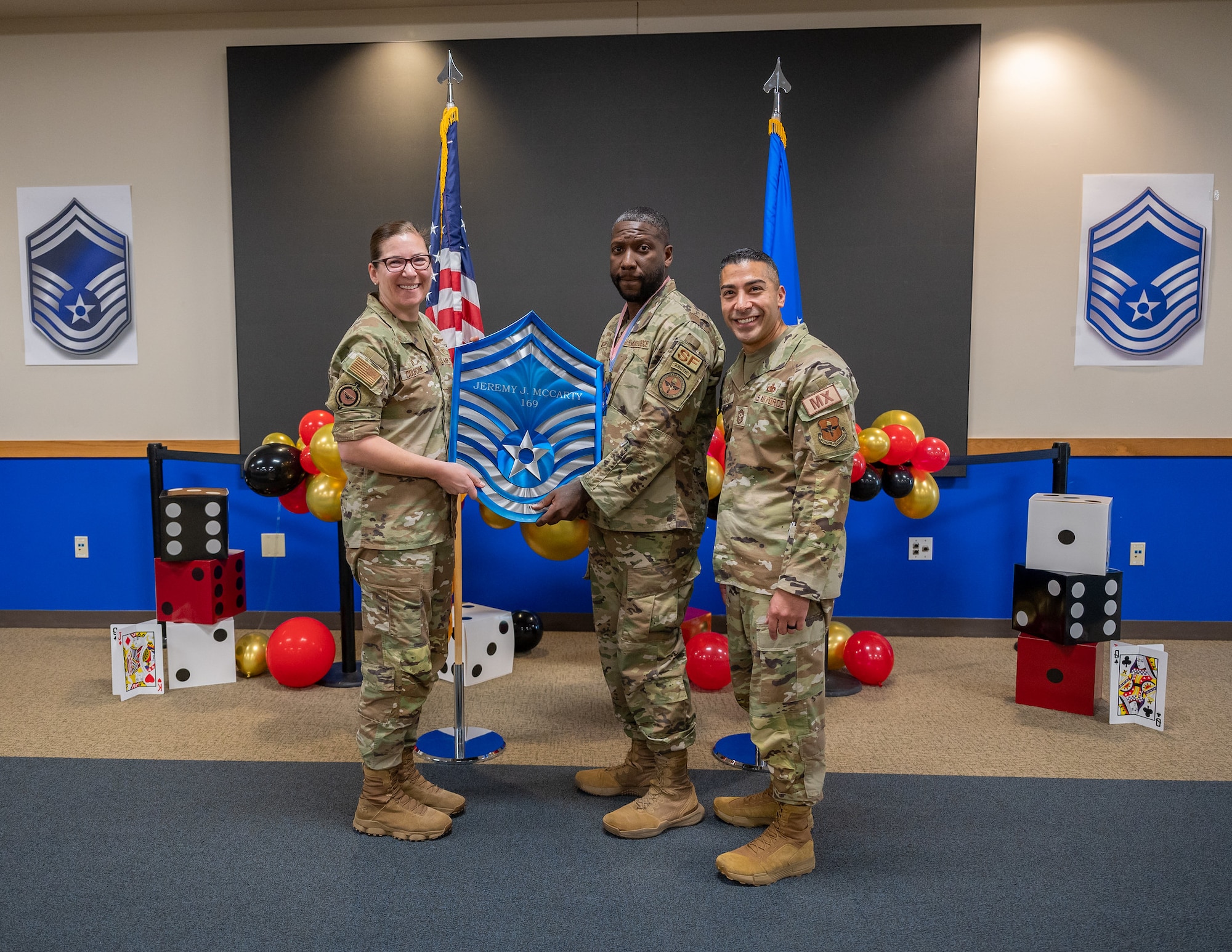Col. Lauren Courchaine, 37th Training Wing commander (left) and Chief Master Sgt. Carlos Damian, 37 TRW command chief (right), congratulate Master Sgt. Jeremy McCarty on his selection for promotion to senior master sergeant March 29, 2024, at Joint Base San Antonio-Lackland, Texas. Courchaine is changing command May 30 and will move into her new role as the Senior Military Assistant to the Under Secretary of the Air Force at the Pentagon, Washington D.C. (U.S. Air Force photo by Gregory T. Walker)