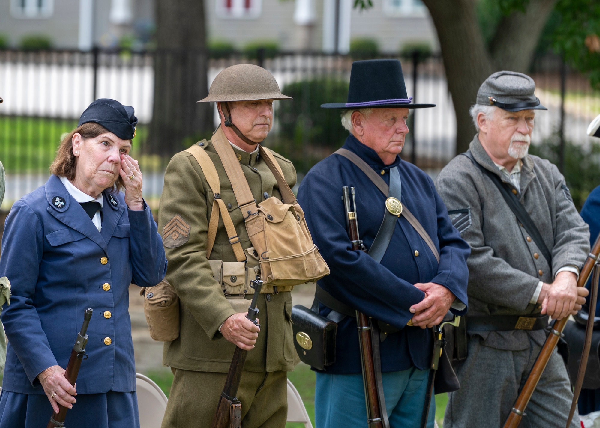 An event participant wipes a tear at the Sunset Hill Cemetery Memorial Day service in Valdosta, Georgia, May 27, 2024. Several participants wore historical uniforms and used weapons from different eras to pay tribute to the heroes who gave their lives in service throughout history. (U.S. Air Force photo by Airman 1st Class Leonid Soubbotine)