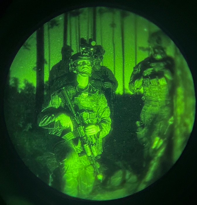 Airmen receive briefing at night