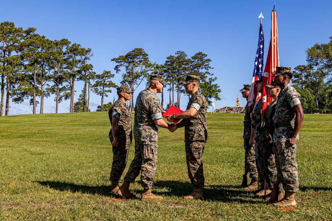 U.S. Marine Corps Lt. Col. Luke A. Sauber (center), the outgoing commanding officer of Combat Logistics Battalion 22, 26th Marine Expeditionary Unit (Special Operations Capable) is awarded the Meritorious Service Medal during a change of command ceremony on Marine Corps Base Camp Lejeune, North Carolina, May 22, 2024. A change of command ceremony signifies the transfer of responsibility, authority and accountability from the outgoing commanding officer to the oncoming commanding officer. (U.S. Marine Corps photo by Cpl. Rafael Brambila-Pelayo)