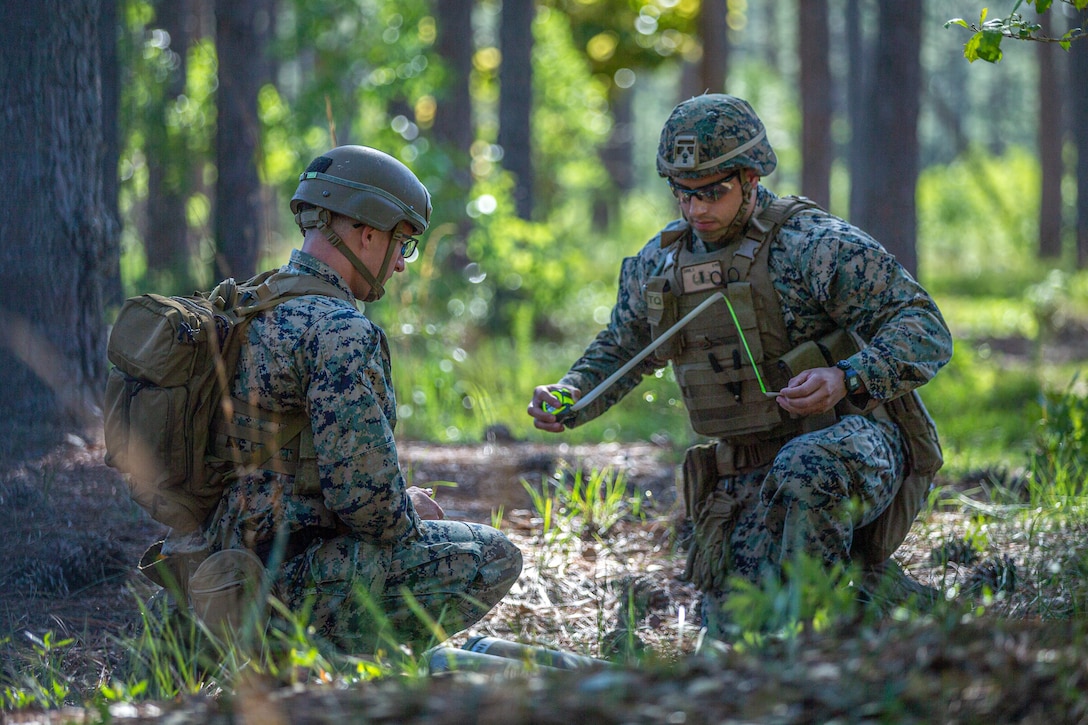 U.S. Marine Corps SSgt. Nicholas Greenisen, left, and Sgt. Eric Curiel both explosive ordnance technicians with EOD Company, 8th Engineer Support Battalion, Combat Logistics Regiment 27, 2nd Marine Logistics Group, prepares to transfer a simulated unexploded ordnance during a base attack recovery exercise as part 2024 EOD Team of the Year Competition on Camp Lejeune, North Carolina, May 21, 2024.  U.S. Marines, U.S. Army and U.S. Air Force EOD Technicians from across the United States, participated in a joint competition hosted by 8th Engineer Support Battalion, 2nd Marine Logistics Group to test individual and team skills while enhancing camaraderie and Esprit de Corps across the joint EOD community. (U.S. Marine Corps photo by Christian Salazar)