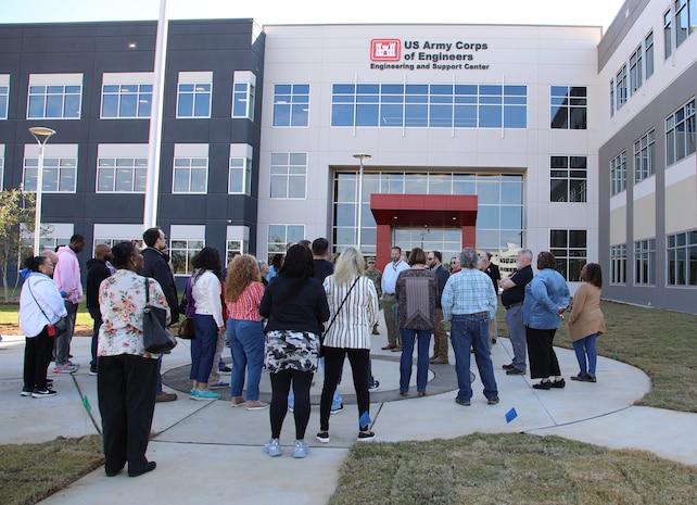 A group of more than two dozen people standing in fron of Huntsville Center's new facility.