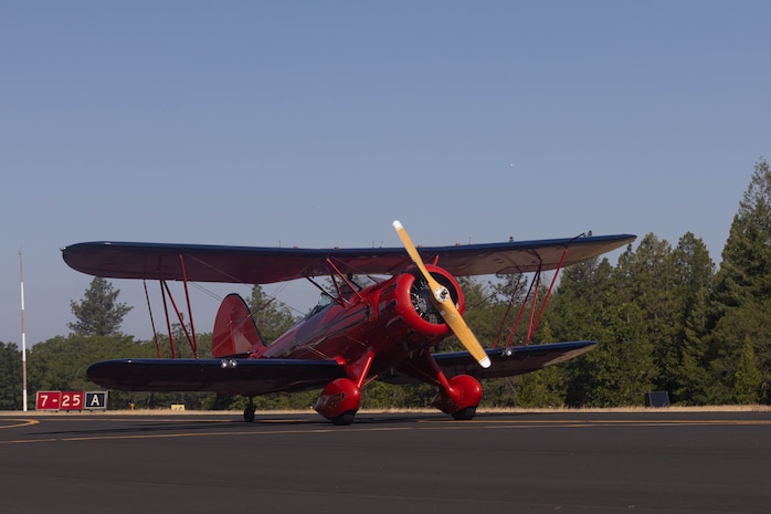 A civilian Biplane strolls down the runway during an air show at Nevada County Airport in Grass Valley, Calif., May 19, 2024. The air show included military and civilian aircraft flyovers, food and drink vendors and a showing from all branches to support an action packed day, celebrating the armed forces. (U.S. Marine Corps photo by Sgt. Ryan Harvey)