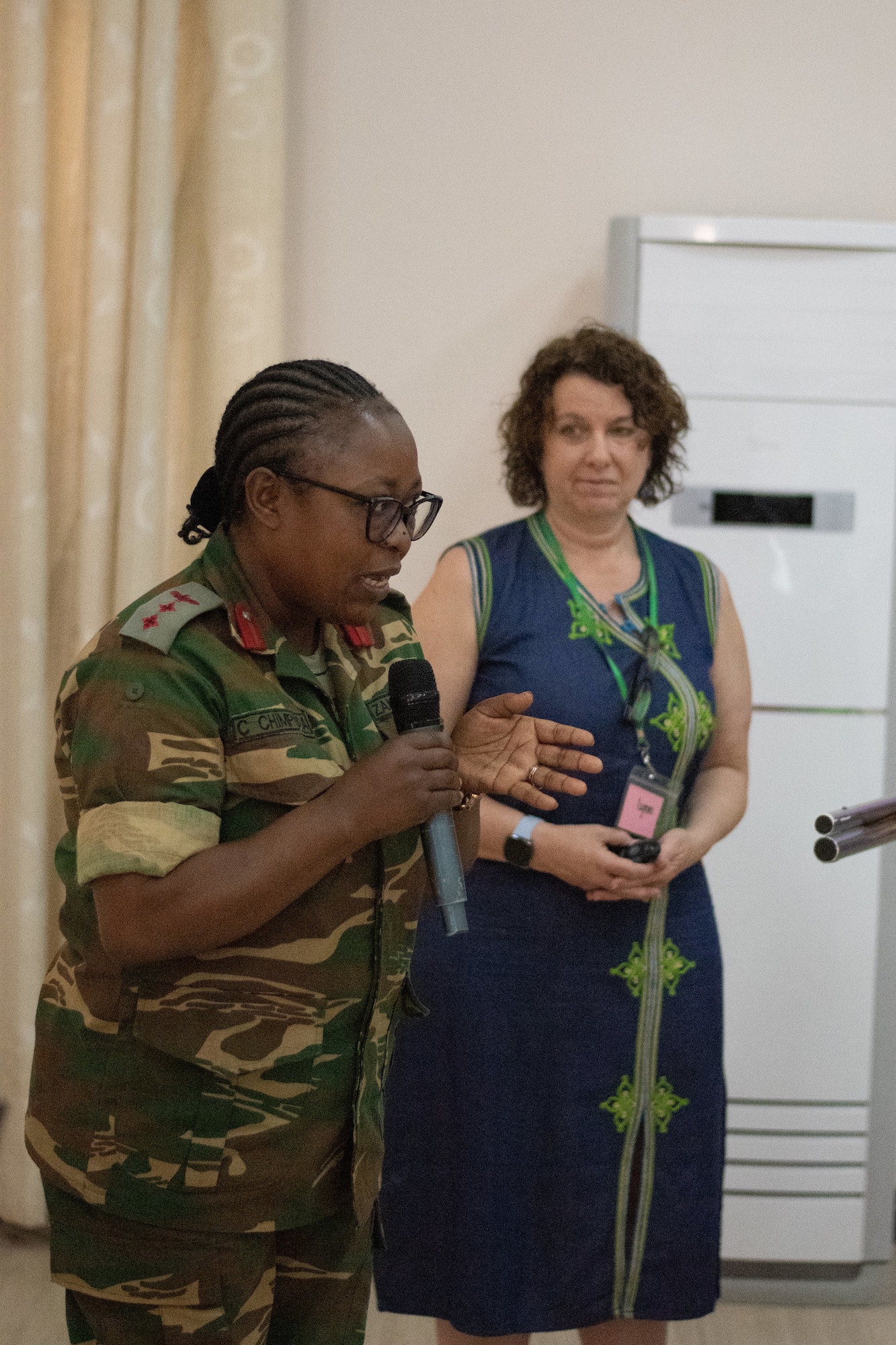 Zambian Army Col Cynthia Chimpusa gives opening remarks, as Dr. Lynn Lawry, lead subject matter expert, prepares to begin the workshop