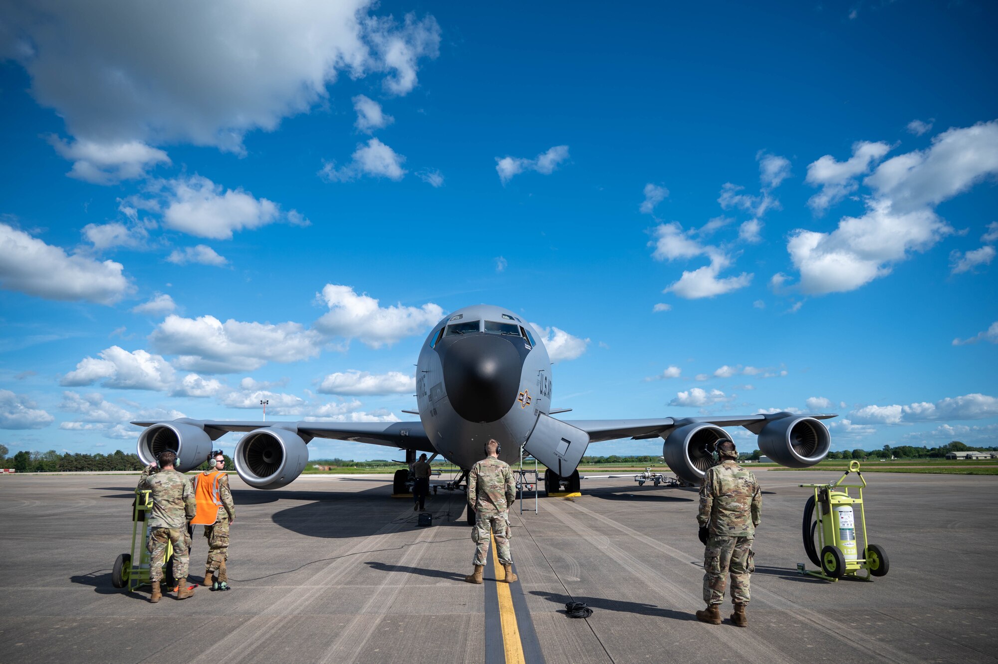 Airmen stand in front of a KC-135
