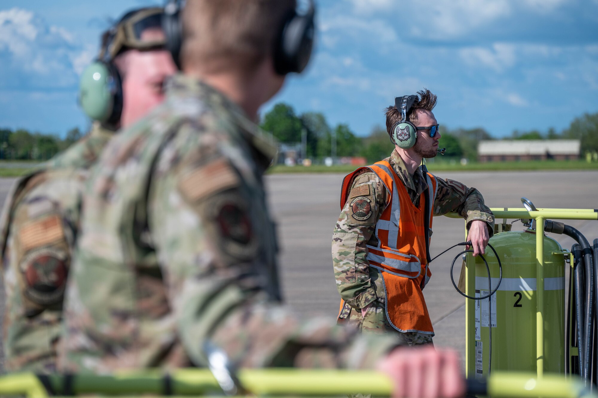 Airmen watch during a hot pit refuel