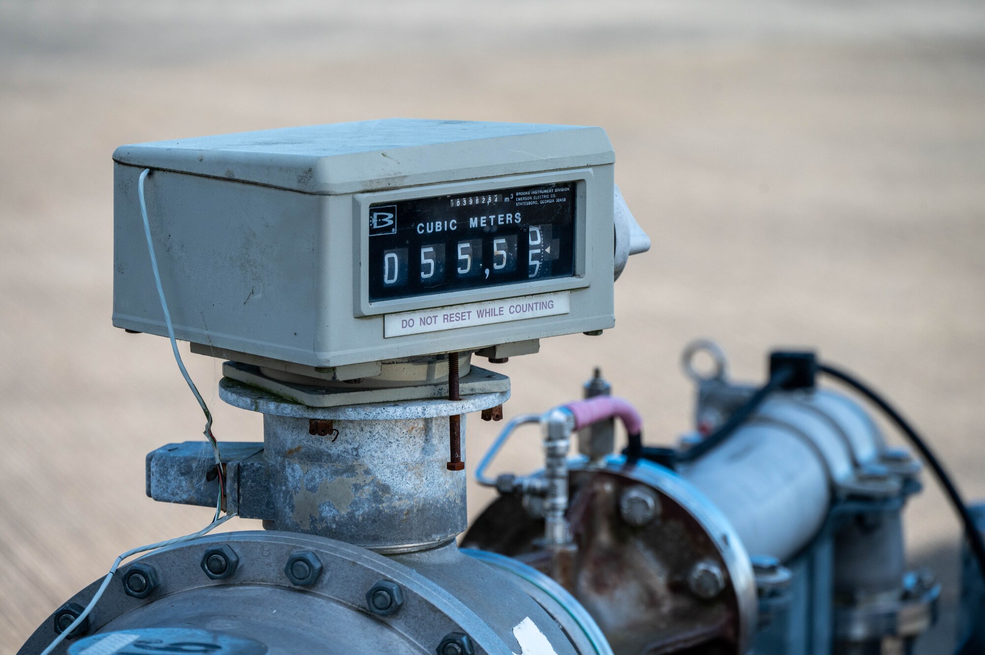 A flow meter reads “55.55 CUBIC METERS”