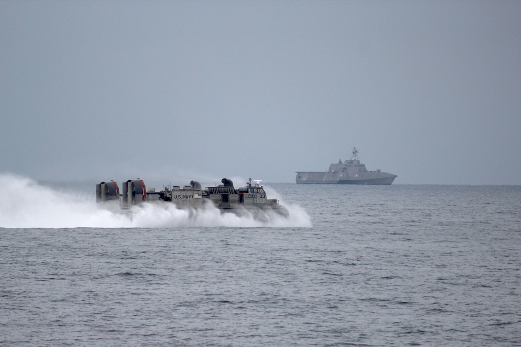 An LCAC transits toward USS Omaha (LCS 12) in the Pacific Ocean.
