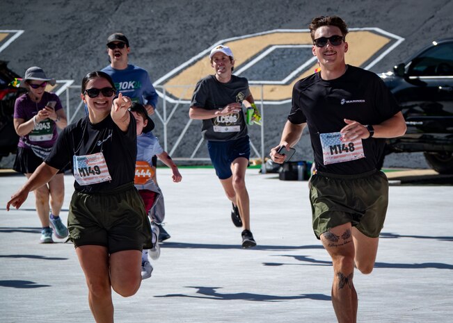 U.S. Marine Corps Cpl. Leilenie Pena, left, a finance technician a combat graphics specialist with Headquarters Company, and Marine Corps Recruit Depot San Diego, and Cpl Bryce Beasley with 1st Distribution Support Battalion, Camp Pendleton California, race to the finish during the BOLDERBoulder 10-kilometer race, at Boulder Colorado, May 27, 2024. MCRDSD and Western Recruiting Region are sending Marines to represent the depot during the 2024 BOLDERBoulder 10k race to engage with the local community and showcase the spirit of our organization.(U.S. Marine Corps photo by Master Sergeant Ezekiel R. Kitandwe)
