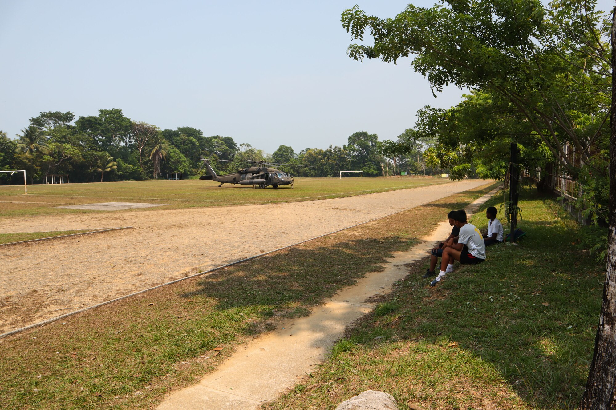 A photo children looking at a helicopter.