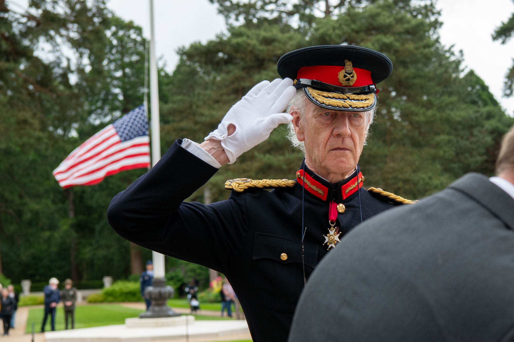 A guest salutes during a Memorial Day ceremony