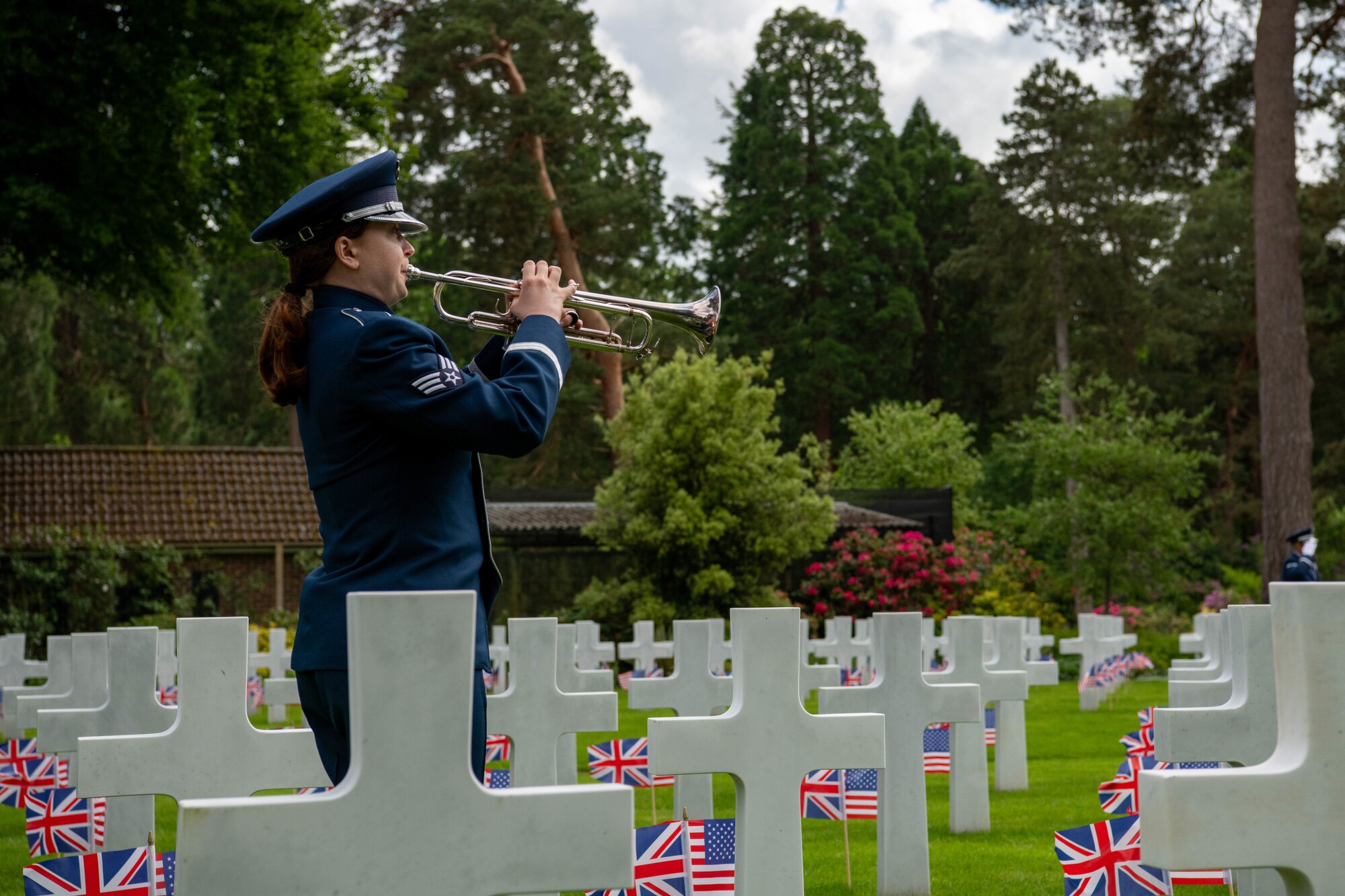 A trumpet player plays taps