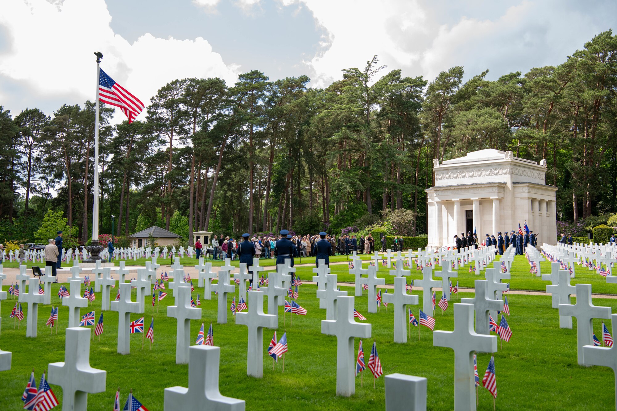 Attendees stand during a Memorial Day ceremony