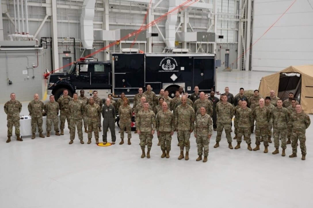 Chief Master Sgt. of the Air Force David A. Flosi and joint base members pose for a photo at Joint Base McGuire-Dix-Lakehurst, N.J., May 23, 2024. Flosi toured the installation with JB MDL leadership team, attending the Parade of Wreaths observance and the 12th Annual Air Advisor Memorial ceremony. (U.S. Air Force photo by Airman 1st Class Aidan Thompson)