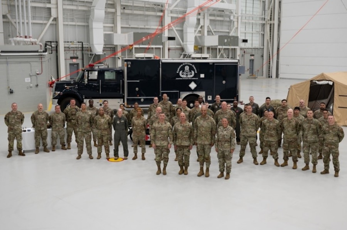 Chief Master Sgt. of the Air Force David A. Flosi and joint base members pose for a photo at Joint Base McGuire-Dix-Lakehurst, N.J., May 23, 2024. Flosi toured the installation with JB MDL leadership team, attending the Parade of Wreaths observance and the 12th Annual Air Advisor Memorial ceremony. (U.S. Air Force photo by Airman 1st Class Aidan Thompson)