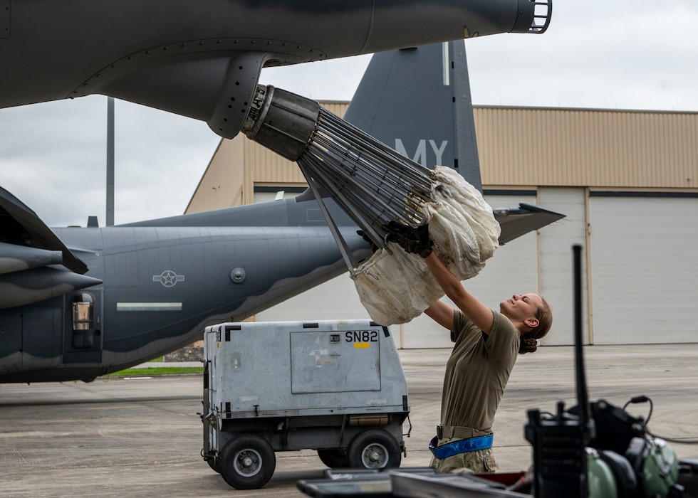 U.S. Air Force Airman 1st Class Anjali Sabaratnam, 71st Rescue Generation Squadron hydraulics systems specialist, catches an in-flight refueling chute on an HC-130J Combat King II aircraft at Moody Air Force Base, Georgia, May 20, 2024. Lengthening the lifecycle of in-flight refueling hoses is important to lessen downtime, maintenance, supply availability and costs. (U.S. Air Force photo by Airman 1st Class Leonid Soubbotine)