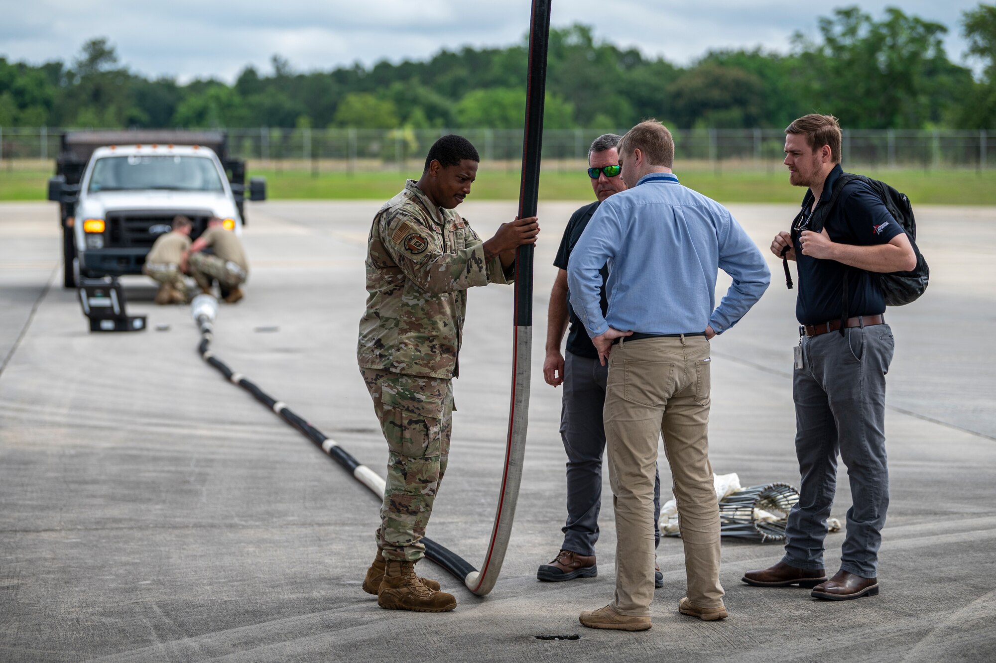 U.S. Air Force Staff Sgt. Kamron Houston, 71st Rescue Generation Squadron hydraulics systems craftsman, talks to a Mercer Engineering Research Center team about the in-flight refueling hose inspection criteria and a review of hose damage trend data at Moody Air Force Base, Georgia, May 20, 2024. The MERC engineers took two deficient hoses for further research and testing to figure out the points of failure and opportunity for improvements. (U.S. Air Force photo by Airman 1st Class Leonid Soubbotine)