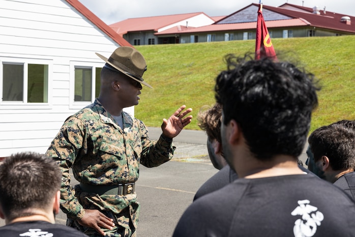 U.S. Marine Corps Sgt. Raekwon Dilworth, a drill instructor with 3rd Recruit Training Battalion, Marine Corps Recruit Depot San Diego, gives instructions to poolees and guests attending the Recruiting Station Portland pool function at Camp Rilea Armed Forces Training Center in Warrenton, Oregon, May 18, 2024. Pool functions are held to prepare poolees for the mental and physical rigors of recruit training. (U.S. Marine Corps photo by Cpl. Andrew Bray)