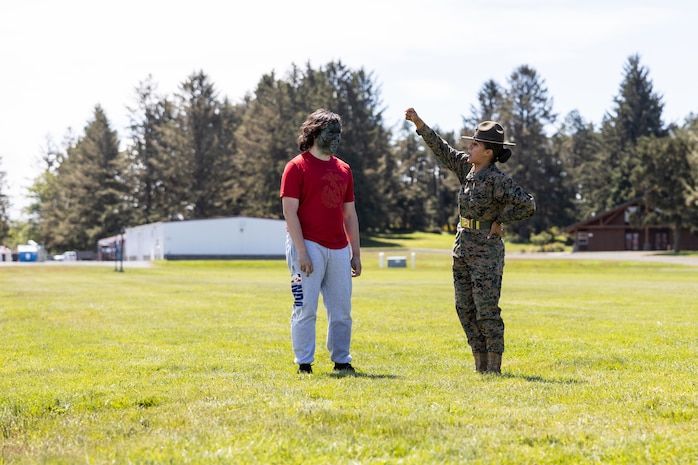 U.S. Marine Corps Staff Sgt. Celise Phillips, a drill instructor with 2nd Recruit Training Battalion, Marine Corps Recruit Depot San Diego, instructs a poolee with Recruiting Station Portland during a pool function at Camp Rilea Armed Forces Training Center in Warrenton, Oregon, May 18, 2024. Pool functions are held to prepare poolees for the mental and physical rigors of recruit training. (U.S. Marine Corps photo by Cpl. Andrew Bray)