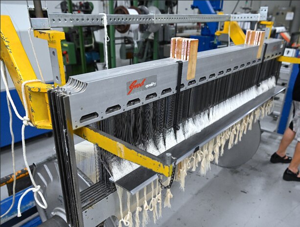 A closeup shot of advanced textile machinery at the Wilson College of Textiles, NC State, during the FEDTEX 2024 conference. This site visit provided an opportunity for the CSS team to connect with industry professionals, engage with students, and collaborate with textile experts (Courtesy photo by NC Military Business Center)