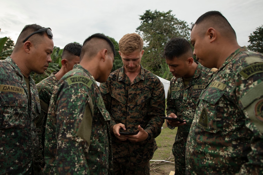 U.S. Marines with 1st Battalion, 7th Marine Regiment, 1st Marine Division, and service members with the Armed Forces of the Philippines take notes during a terrain walkthrough for Archipelagic Coastal Defense Continuum in Barira, Philippines, May 26, 2024. ACDC is a series of bilateral exchanges and training opportunities between U.S. Marines and Philippine Marines aimed at bolstering the Philippine Marine Corps’ Coastal Defense strategy while supporting the modernization efforts of the Armed Forces of the Philippines. (U.S. Marine Corps photo by Cpl. Kayla Halloran)