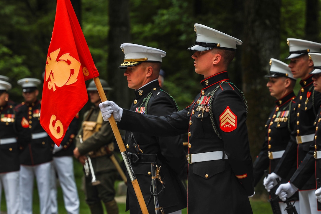 U.S. Marines with 6th Marine Regiment stand at parade rest during a wreath laying ceremony at the Iron Mike statue, Belleau, France, May 26, 2024. The ceremony was held in commemoration of the 106th anniversary of the battle of Belleau Wood, conducted to honor the legacy of service members who gave their lives in defense of the United States and European allies. (U.S. Marine Corps photo by Sgt. Alexa M. Hernandez)