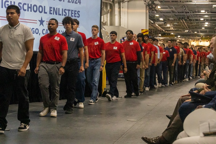 High school seniors, military service members and their families attend Our Community Salutes San Diego 2024 at the USS Midway Museum in San Diego, Calif., May 20, 2024. The Our Community Salutes program recognizes and supports high school seniors who plan to enlist into the military immediately after high school graduation, and provide them with resources that aid in their transition into military service. (U.S. Marine Corps photo by Sgt. Jesula Jeanlouis)